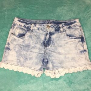 Jean shorts with lace strip on bottom part.